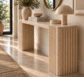 Hand-carved travertine console table with asymmetric slab and fluted leg