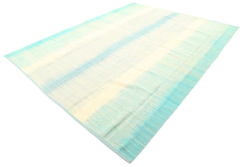 Aqua and ivory coastal flatweave rug viewed from an angle