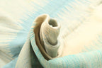Folded aqua blue and ivory handmade coastal wool rug