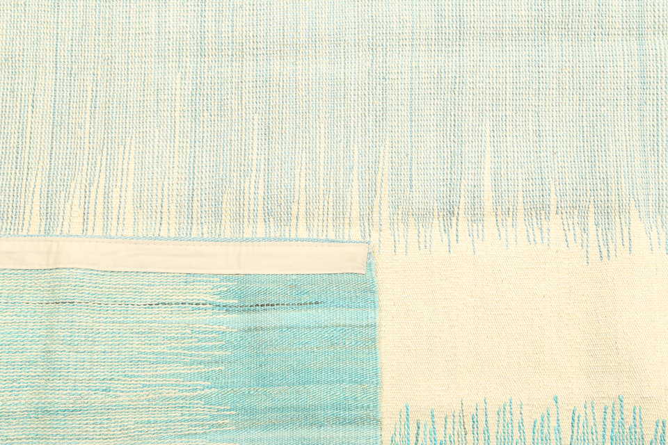 Reversible construction detail of aqua and ivory coastal kilim rug