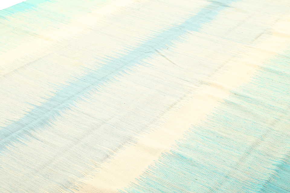 Soft aqua blue and ivory coastal rug surface detail