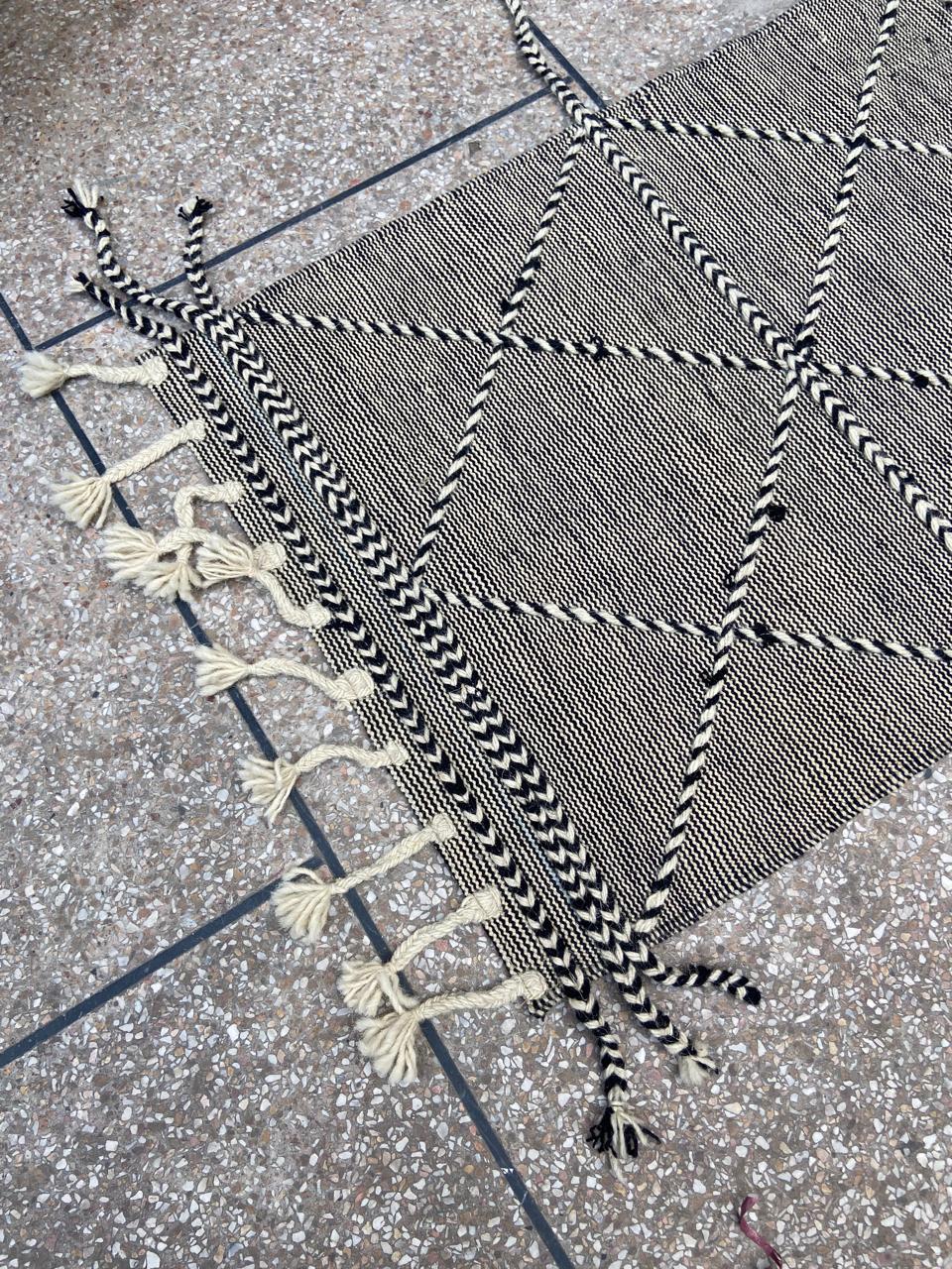 Hand-braided edging and tassels on black and ivory kilim runner