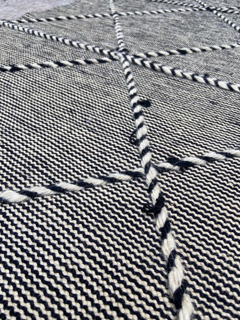 Close-up of braided diamond pattern on handwoven wool runner