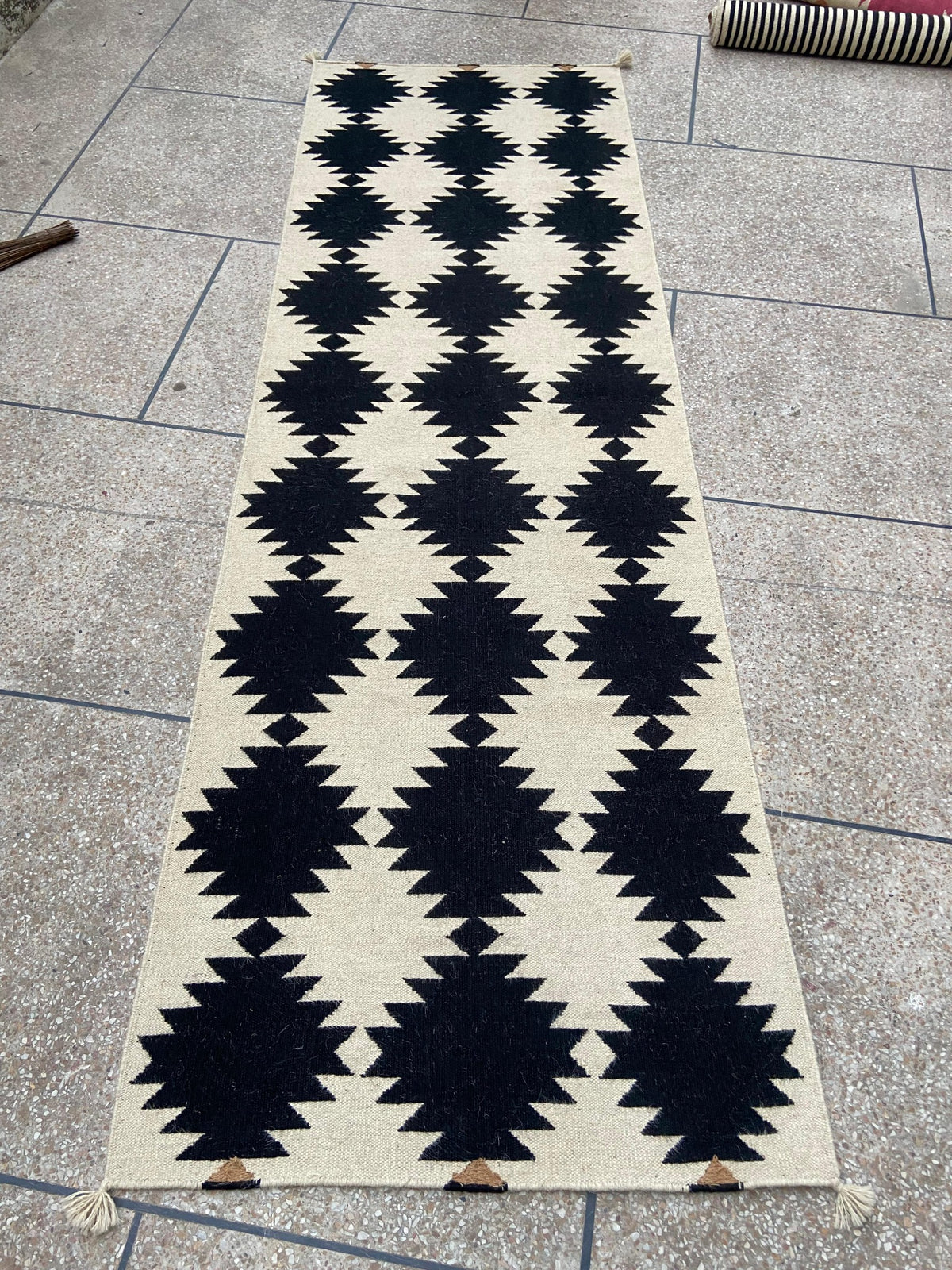 Full view of black and ivory handwoven wool kilim runner