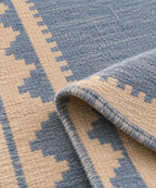 Folded close-up of blue and ivory handwoven wool runner