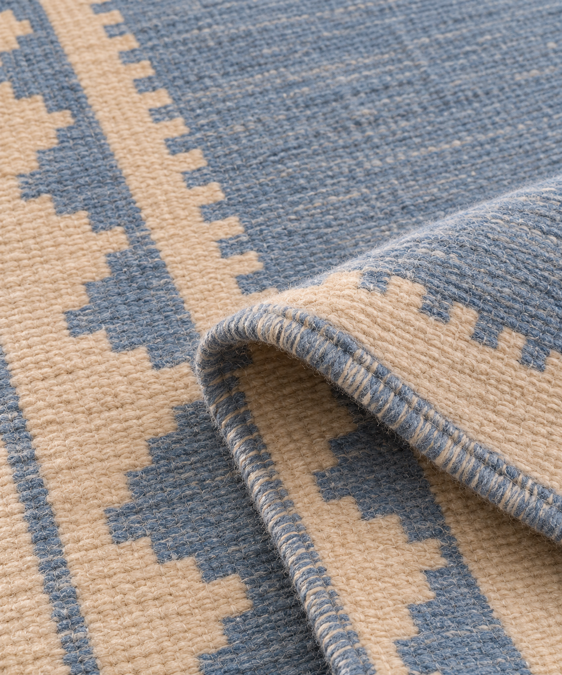 Folded close-up of blue and ivory handwoven wool runner