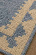 Close-up of blue and ivory stepped geometric wool weave
