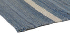 Hand-finished edge of denim blue and ivory wool kilim rug