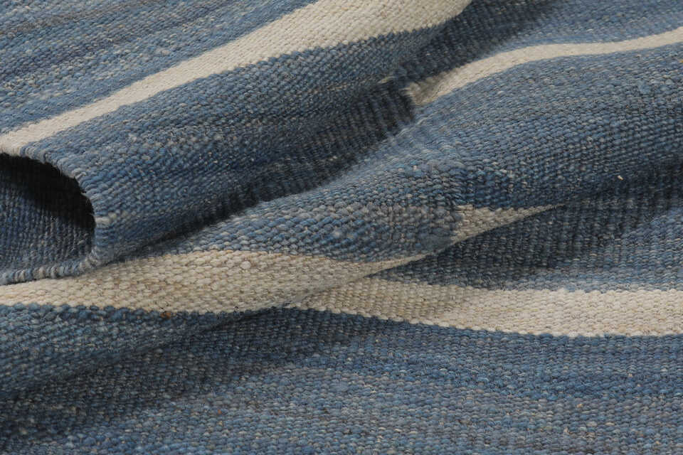 Folded denim blue and ivory reversible wool kilim rug