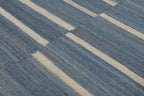 Close-up of irregular ivory stripes on denim blue flatweave