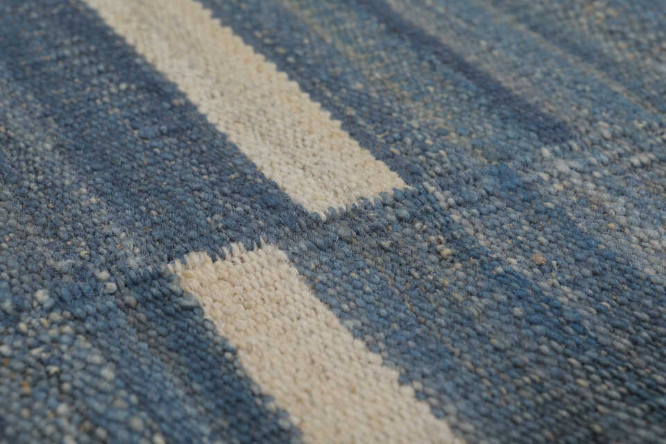 Detailed handwoven wool texture of blue coastal kilim rug