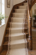 Dusty rose floral wool kilim stair runner installed on an antique wooden staircase