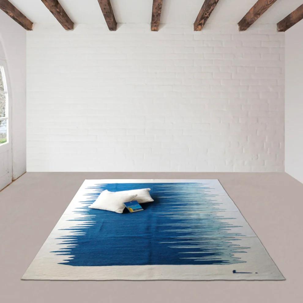 Indigo blue gradient kilim rug styled in a room