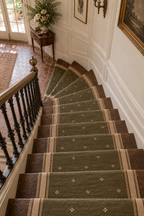 Olive green wool kilim runner with cream motifs and cream striped side borders, angle view