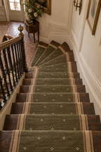 Olive green wool kilim runner with cream motifs and cream striped side borders, stairs view
