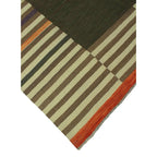 Corner detail of olive green, rust and ivory geometric kilim rug