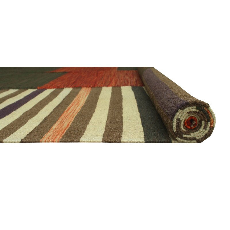 Rolled edge of olive, rust and ivory handmade wool kilim rug