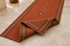 Close-up of rust burgundy and mustard tribal wool kilim hallway runner