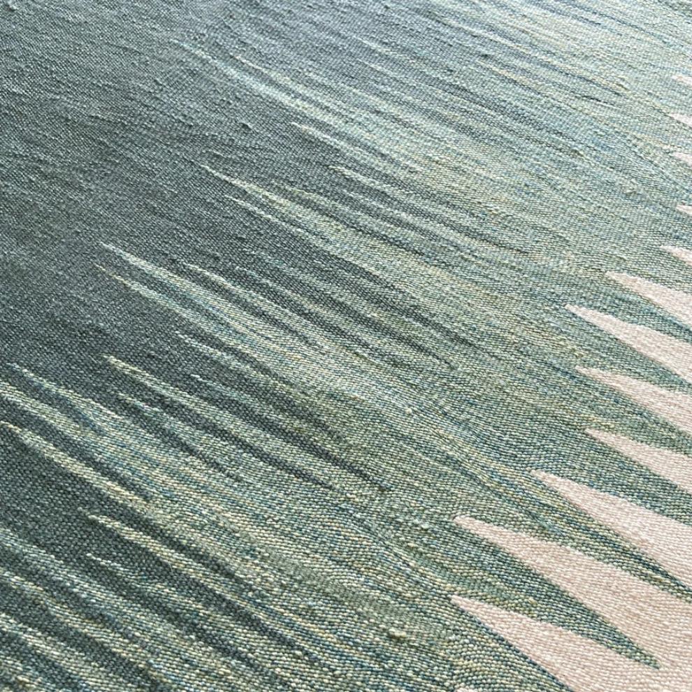 Close-up of sage green and ivory handwoven flatweave texture