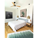 Sage green gradient kilim rug styled in a bedroom