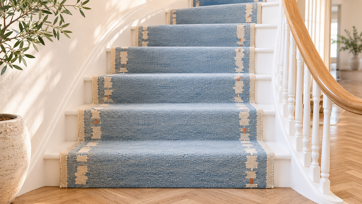 Sky blue and ivory handwoven runner on a curved staircase